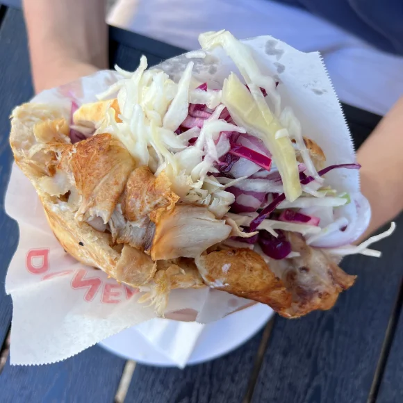 Döner im Papier, gehalten von zwei Händen